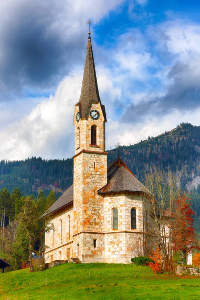 istock Mountains over Gosau village with Catholic Church under Sunlight 1026843666