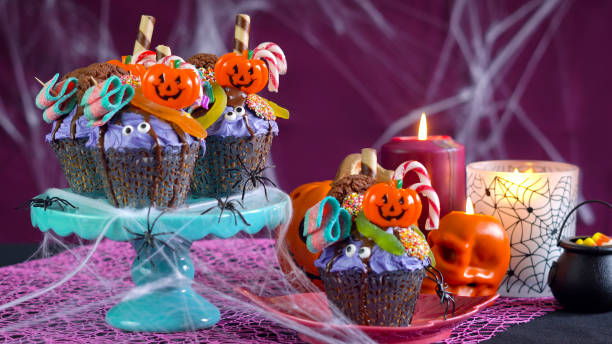 istock Halloween candyland drip cake style cupcakes in party table setting 1026846024