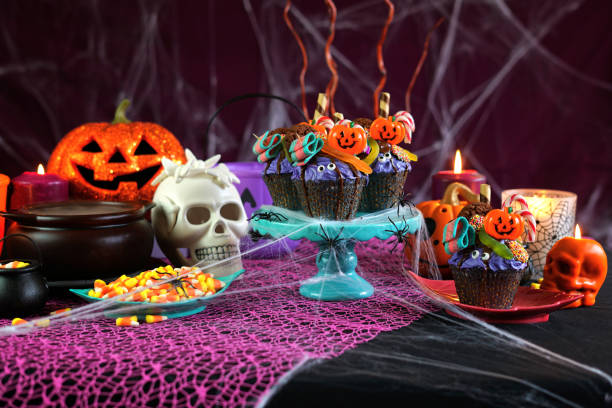 istock Halloween candyland drip cake style cupcakes in party table setting 1026846198