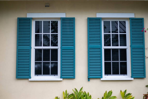 Two Outdoor Windows with Outdoor Window Shutter Windows on a home shutter stock pictures, royalty-free photos & images