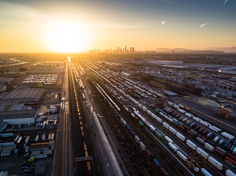 Aerial shot of an intermodal train and trucking distribution yard the city of Vernon, California. This is an industrial area surrounded by the City of Los Angeles, made up of factories, warehouses and meatpacking plants.