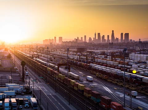 Intermodal Freight Yard with Los Angeles Skyline at Sunset