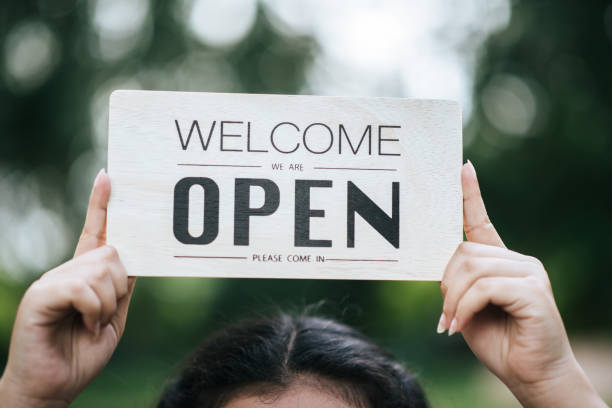 istock Girl holding an open sign 1026862198