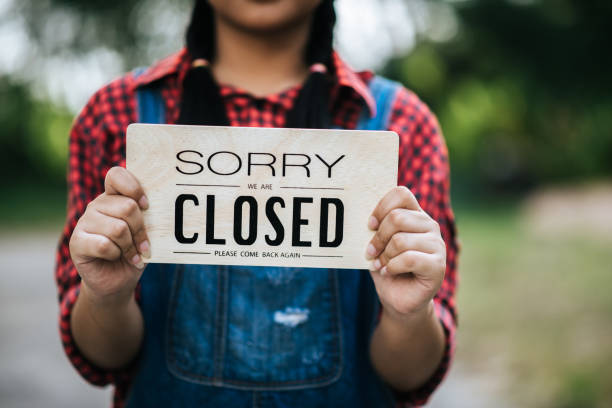 istock Girl holding an closed sign 1026862202