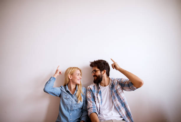 istock Happy young modern couple standing against the wall. 1026867548