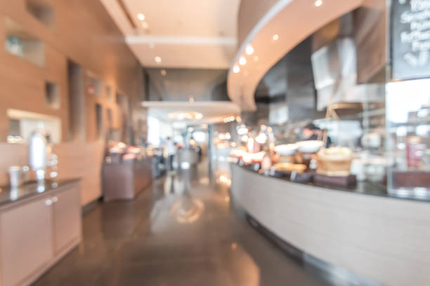 istock Buffet at hotel restaurant interior blur background with blurry open kitchen counter bar of food catering service business with chef staff cooking for breakfast, lunch or dinner meal 1026871380