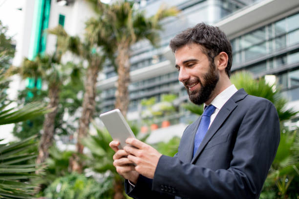 istock Happy business man looking at his tablet 1026871744