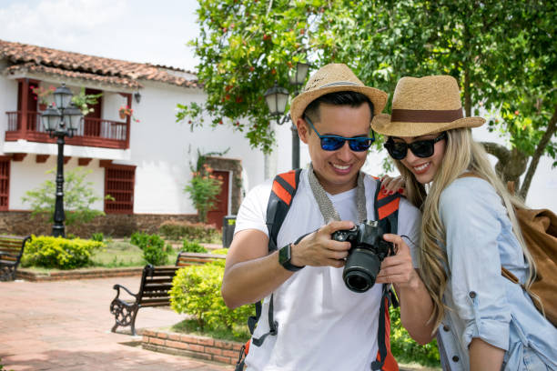 istock Tourists in a town taking pictures with a camera 1026871842
