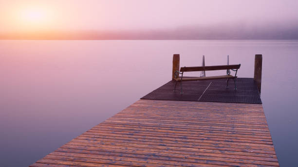 istock Empty footbridge with a bench on a lake Altausseer at sunrise 1026874850