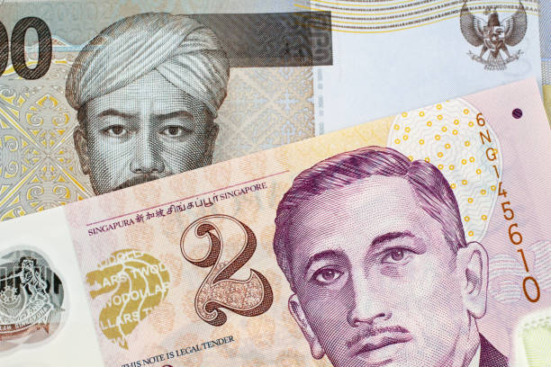 istock An Indonesian 2000 Rupiah bank note with a Two Singapore Dollar Bank Note 1026878222