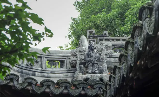 Photo of The old man statue, on the top of the roof.