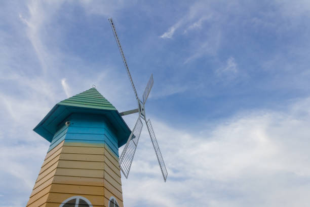 Low angle of wood windmill, clouds, blue sky