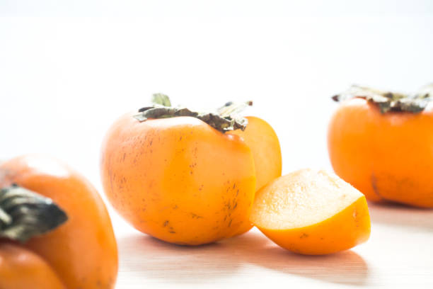 istock Persimmon on a white background, persimmon orange in front view. 1026930810
