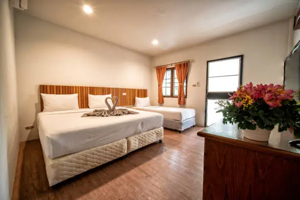 interia perspective of triple hotel bedroom with one twin bed and one double bed for three persons at Samed Cabana Samed island Rayong district Thailand