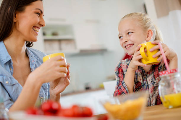 istock Mom and daughter having breakfast 1026936612