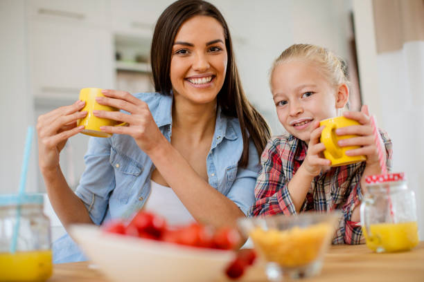 istock Mom and daughter having breakfast 1026936762