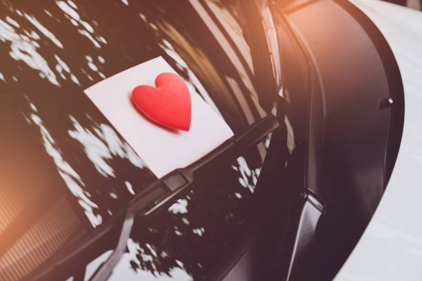 istock love letter heart on a sticky note under a windshield .vintage  color style 1026942258