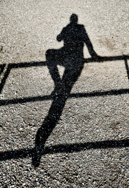 istock Shadow person balancing on a rail 1026942428