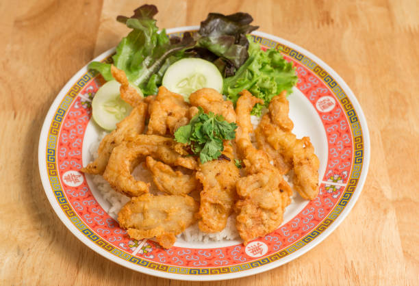 istock Fried chicken place on top the rice with cucumbers and sauce. 1026947642