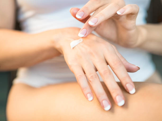 istock Young woman applying hand cream, closeup view 1026948232