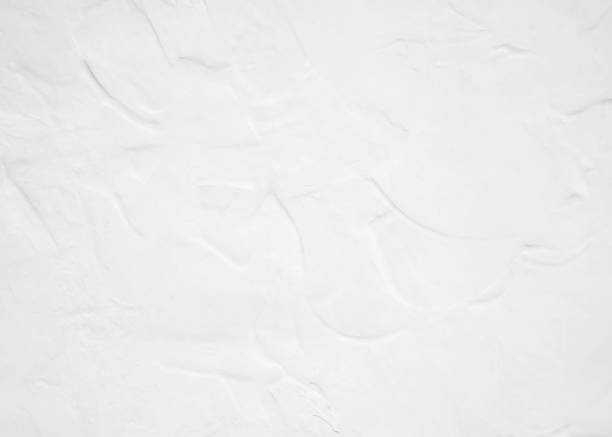 istock White pastel rough crack cement texture stone concrete,rock plastered stucco wall; painted flat fade background gray solid floor grain. 1026957444