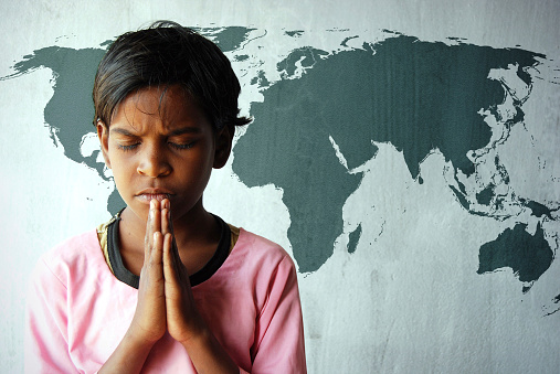 Rural Indian child praying for world peace - world map on wall. Source - http://www.lib.utexas.edu/maps/world_maps/world_rel_803005AI_2003.jpg