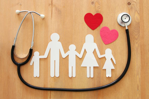 Health Insurance . concept image of Stethoscope and family on wooden table. top view Health Insurance . concept image of Stethoscope and family on wooden table. top view medical insurance stock pictures, royalty-free photos & images