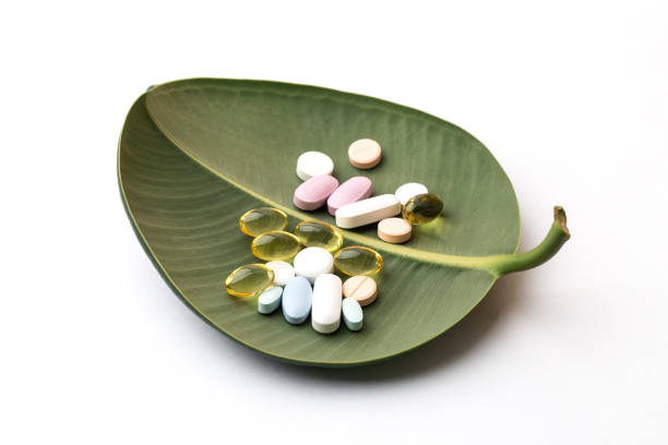 istock Pills on leaf isolated, medical concept. 1026963700