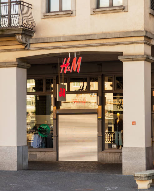 Entrance to the H&M store on Limmatquai quay in Zurich, Switzerland Zurich, Switzerland - August 26, 2018: entrance to the closed on Sunday H&M store on Limmatquai quay. H&M is a brand of the Hennes & Mauritz AB which is a Swedish multinational clothing-retail company known for its fast-fashion clothing, operating in numerous countries. h and m stock pictures, royalty-free photos & images