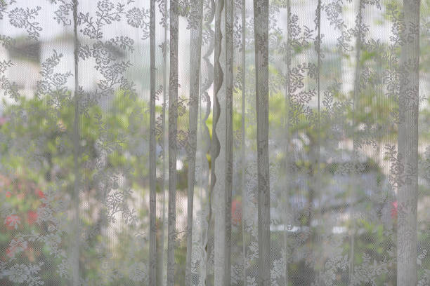 istock The lace curtain at a glass window. 1026966968