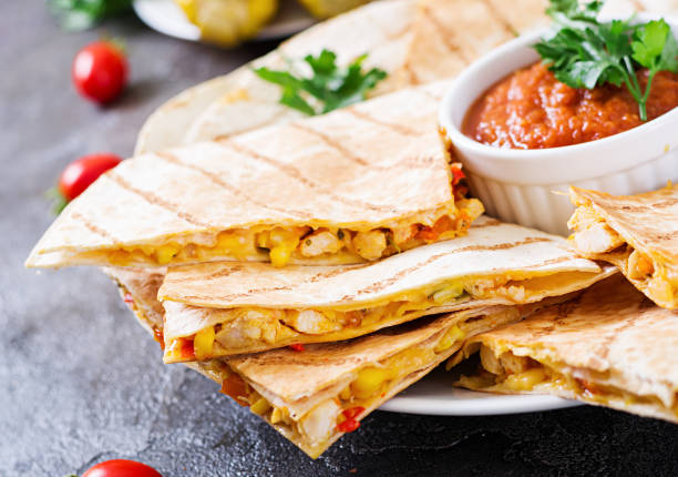 istock Mexican Quesadilla wrap with chicken, corn and sweet pepper and tomato sauce 1026976548