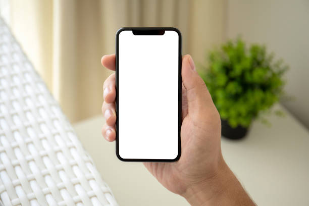 istock man hand holding phone with isolated screen in room house 1026983304