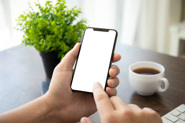 istock man hands holding phone with isolated screen in office 1026985158