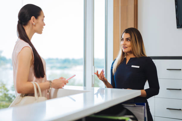 istock Intelligent nice woman working at the reception 1026993098
