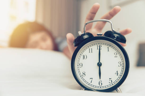 lazy to wake up girl hand off alarm clock ring on bed at morning Monday lazy to wake up girl hand off alarm clock ring on bed at morning monday the early bird catches the worm stock pictures, royalty-free photos & images