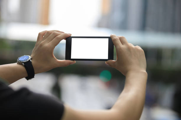 istock Hands hold smartphone take pictures in modern city 1026995532