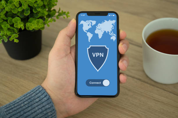 istock Male hand holding phone with app vpn creation Internet protocols 1026996148