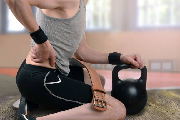 istock back injury during exercise, weight-lifting 1026999536