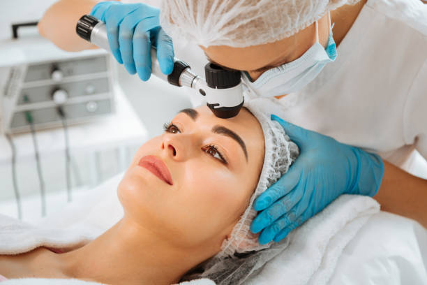 istock Skilled female dermatologist using modern professional equipment 1027002360