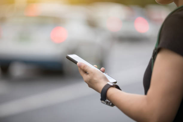 istock Woman hands using smartphone at city street side,checking the ride-hailing apps 1027002364