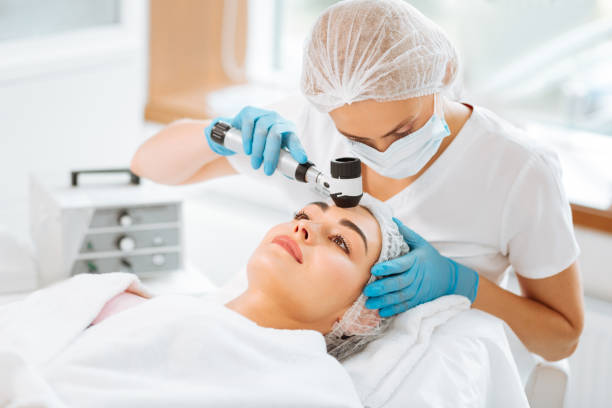 istock Nice skilled female dermatologist holding a dermatoscope 1027002856