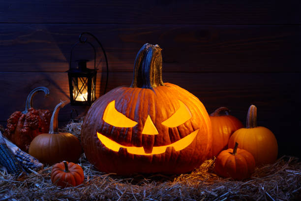 istock Halloween pumpkin jack lantern in dark barn, holiday concept 1027015690