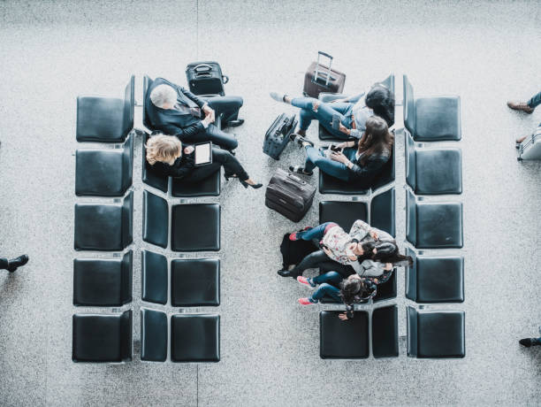 istock Group of people waiting for a plane in lobby 1027016220