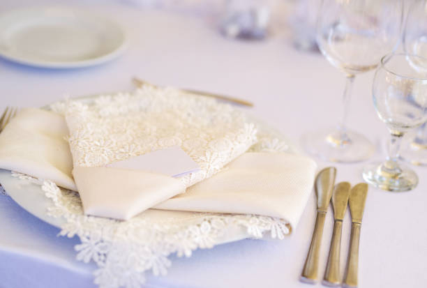 istock Beautiful table set up - white cloth napkin and a plate 1027016624