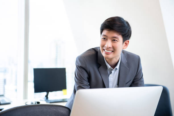 istock Young smiling Asian businessman in the office 1027016800
