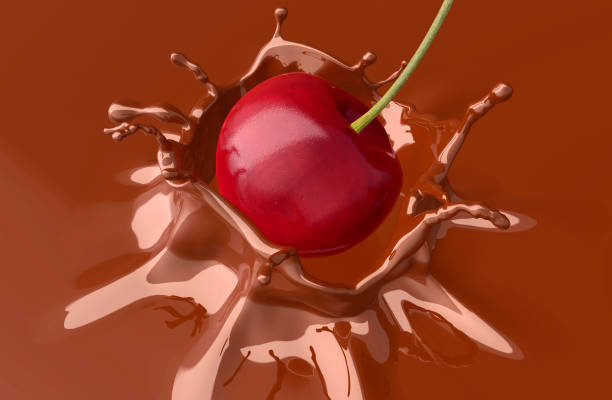 istock red cherry falling and splashing into chocolate. 1027022786