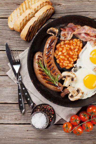 istock English breakfast. Fried eggs, sausages, bacon 1027023136
