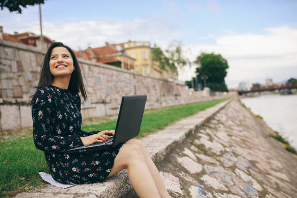 istock Young woman working on lap top outdoors 1027023370