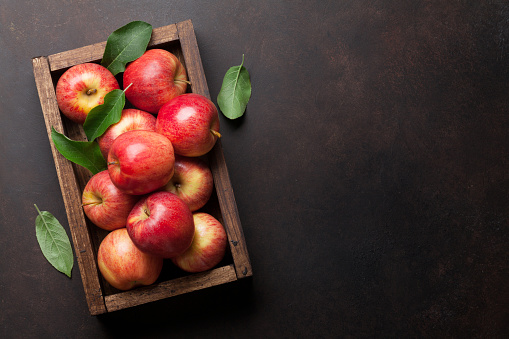 Red apples in wooden box