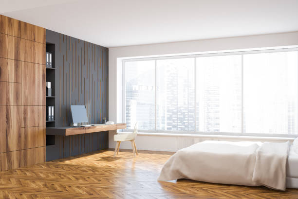 istock Panoramic white, black, wooden bedroom home office 1027026982